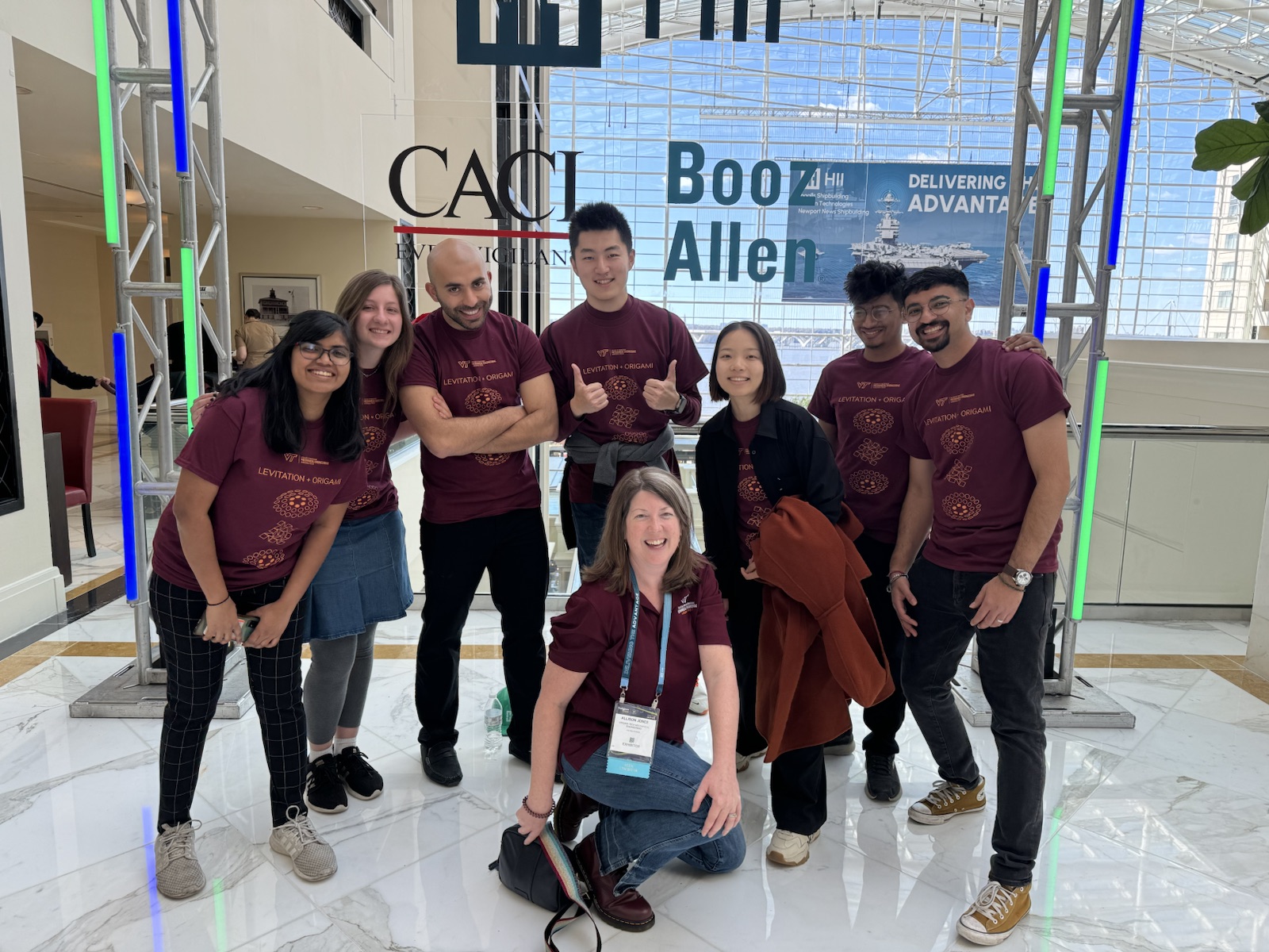 Ziyang Zhou standing with DARE Lab colleagues at a research conference